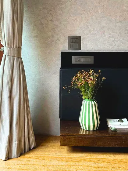 A quiet corner in the Baan Sukh bedroom. The simple, clean lines of the floating bedside table and the texture of the wall finish create a sense of calm, embodying our philosophy of slow living and intentional design.