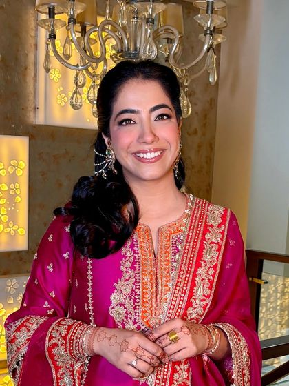 A close-up portrait of Tanisha. Her smile lights up the photo, and the makeup is perfectly understated and elegant.
