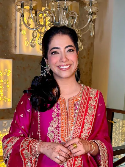 A close-up portrait of Tanisha. Her smile lights up the photo, and the makeup is perfectly understated and elegant.