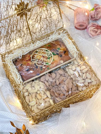 An inside look at my mesh box Diwali hamper. It’s neatly packed with a 250-gram tea cake and three kinds of roasted nuts: salted almonds, cashews, and pistachios. A perfect balance of sweet and savory.