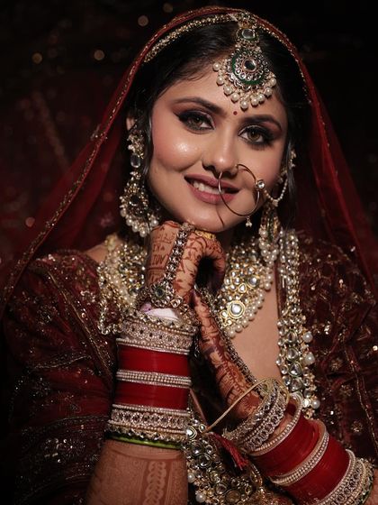 The elegance and royalty of a bride. This close-up shot highlights the beautiful smile and the detailed jewellery.