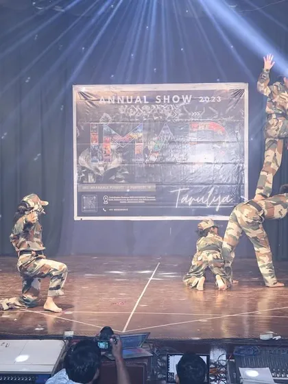 A different view of the army-themed human tower, highlighting the stability and trust required from each team member to execute the pose perfectly.
