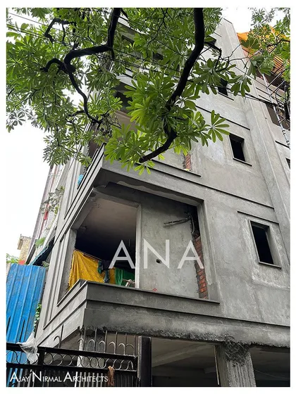 The corner of the Yellow Line Apartment during the early stages of facade work. The raw concrete structure shows the projections and openings that will be finished later.