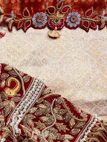 Another angle of the sleeve tassel, showing the intricate bird motif. I put as much care into the tassels as I do into the blouse itself.