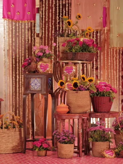 A cozy corner at a Mehendi function, styled with a "Dil Dhadakne Do" theme. We used wicker baskets, sunflowers, and rani pink accents to create a vibrant, bohemian photo opportunity.