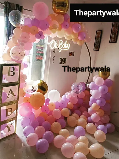 A cascade of pastel balloons for a baby shower. This style of decoration is great for filling a corner and creating a beautiful photo opportunity.