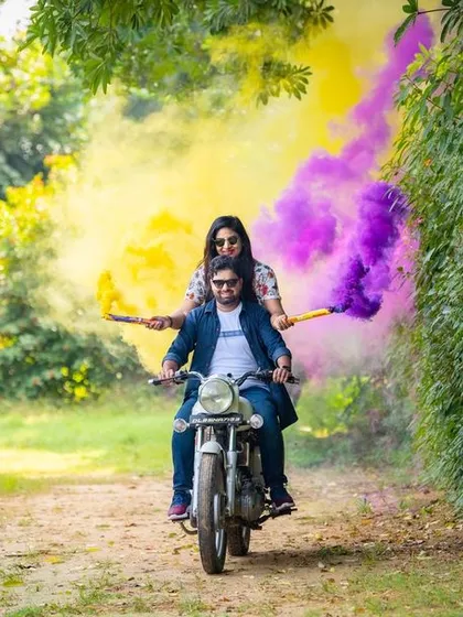 Let's have some fun with your pre-wedding shoot. This couple wanted something energetic and colorful, so we used smoke bombs while they rode a motorcycle through a green pathway. It’s a great way to show your playful side.
