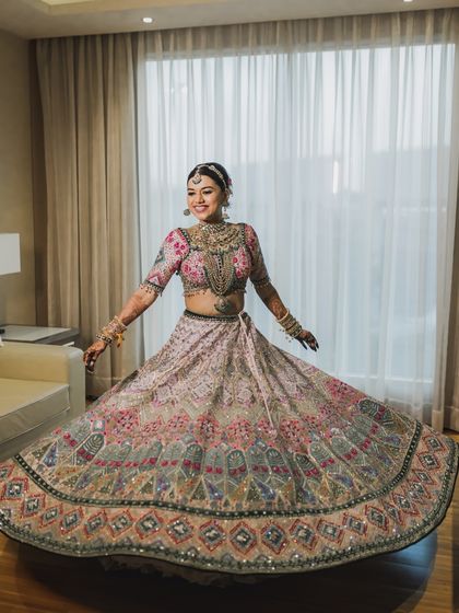 A joyful bride twirls in her stunning lehenga. We love capturing these happy, carefree moments during the getting ready process.