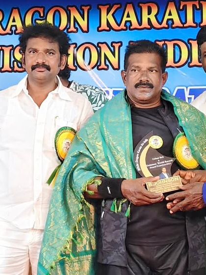 Receiving an award from a master at the White Dragon Karate Do ceremony. Mutual respect is the foundation of martial arts.