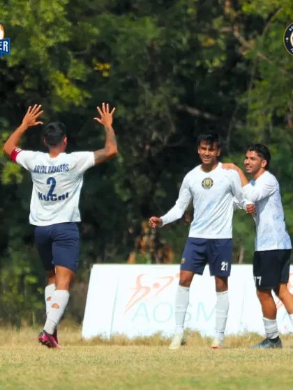 The pure joy of scoring. Players celebrate together after finding the back of the net, a moment of shared success.