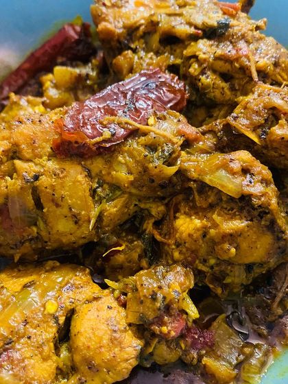 A close-up of the rich and spicy chicken curry.