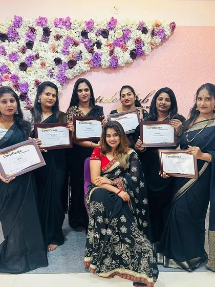 This is the goal: becoming a certified professional. I am so proud to stand with my graduating students, each holding their certificate of completion. They are now talented nail technicians ready to take on the industry.