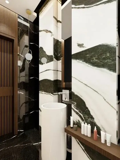 A powder washroom designed with dramatic flair, using a combination of Panda marble with its striking green and white veins, and dark Belgium Black marble. The vertical wooden slats and pedestal sink add layers of texture and sophistication.