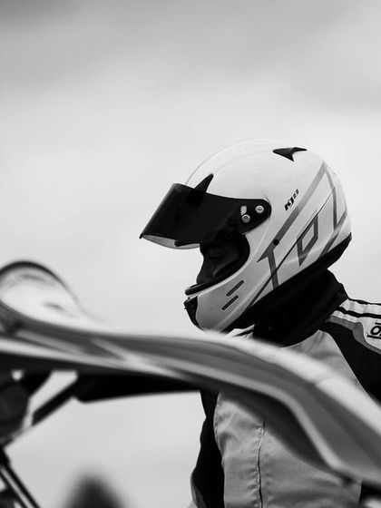 A black and white photo capturing the essence of Ayrton Senna's famous quote: "The harder I push, the more I find within myself."