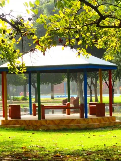 A colorful gazebo in Leisure Valley Park, Gurgaon, a public project we worked on. The structure provides a simple, cheerful shelter for park visitors, surrounded by green lawns and trees.