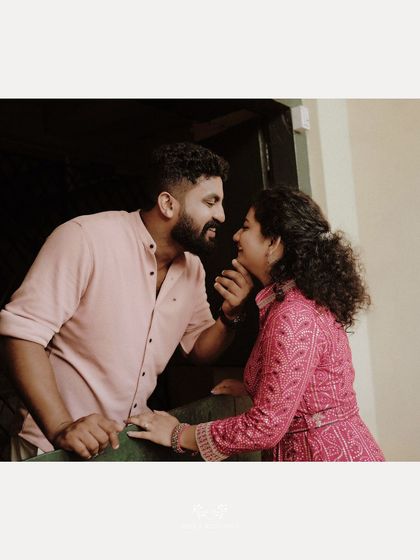 An intimate close-up of a couple sharing a tender moment on a balcony.