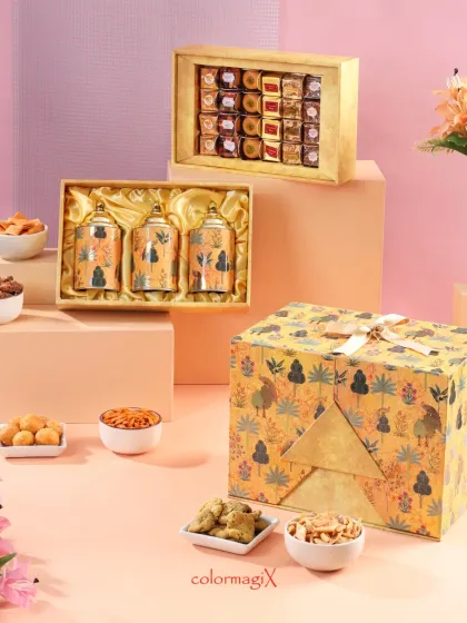 The closed yellow peacock print hamper, showcasing its beautiful design and the smaller sweet and jar boxes that coordinate with it.