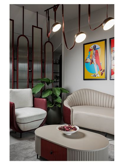 The salon's waiting lounge is a blend of comfort and high style. I used custom-designed furniture, including a fluted sofa and a two-tone armchair, paired with vibrant pop art to create a chic and inviting atmosphere.