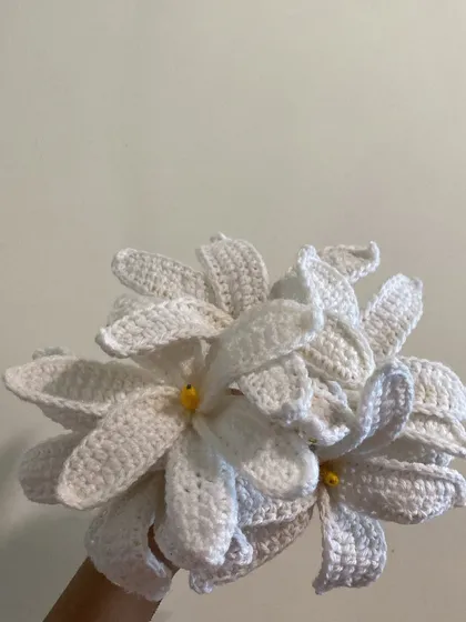 Another angle of the white lily bouquet, showing the delicate yellow stamens inside each flower.