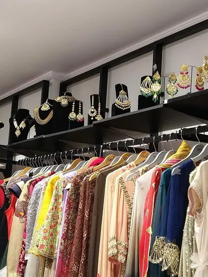 Racks of ethnic wear are organized for easy browsing, with a selection of matching rental jewellery displayed on the shelves above.