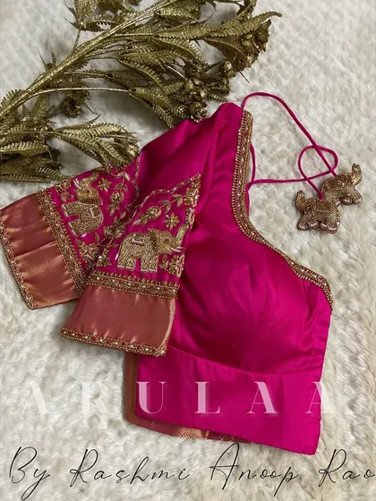 For this lovely pink bridal blouse, we incorporated auspicious elephant motifs into the sleeve embroidery. The custom latkans are also shaped like elephants, adding a unique and personal touch to the design.