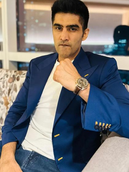 Boxer Vijender Singh redefines classic elegance in a blue formal jacket. Featuring handcrafted detailing over the buttonholes and wide golden buttons, this piece is a timeless work of art.