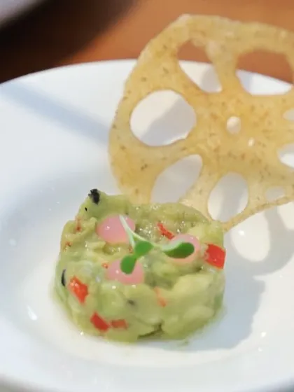 A delicate avocado tartare with a crispy lotus root chip. Even in a minimalist setting, we focus on texture and beautiful presentation for each dish.
