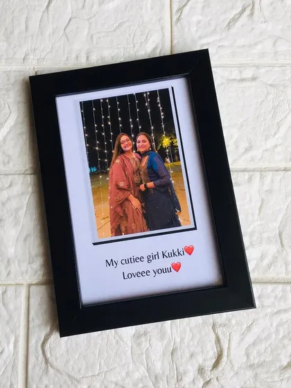 A simple yet elegant 4x6 inch framed gift, featuring a single photo with a personalized caption written below it.