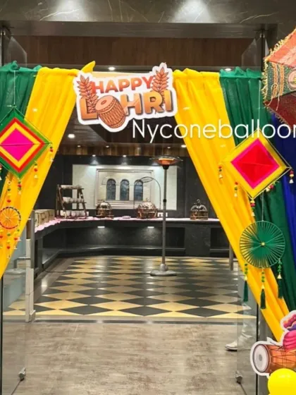 This is an entrance arch I created for a Lohri celebration. I used bright yellow, green, and blue drapes with traditional Punjabi hangings and umbrellas to welcome guests and set a festive mood right from the door.