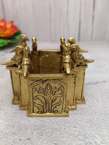 A unique brass Tulasi pot (Vrindavan) with parrots sitting on the sides, a very artistic piece for your pooja room.