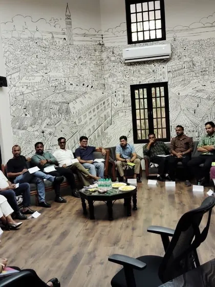 A management training session taking place in the informal, amphitheater-style seating area of our Pune office.