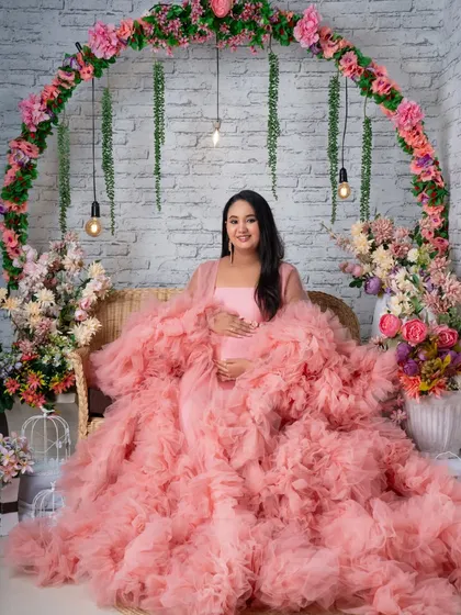 Another beautiful seated portrait in the pink gown, showcasing the versatility of our floral arch set.