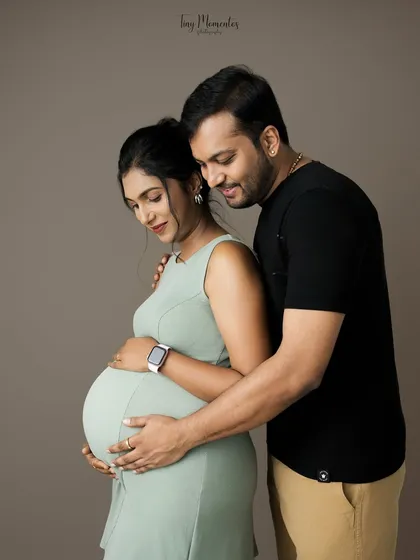 A tender embrace from behind, this pose is perfect for showcasing the baby bump while capturing the supportive love of a partner.