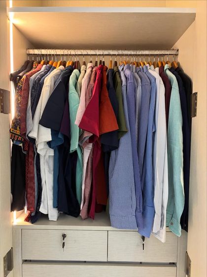 For men's wardrobes, simplicity is key. Here, we've organized all the shirts together, making the morning routine quick and efficient. A simple, logical layout is the secret to a closet that stays tidy.