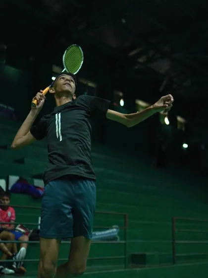 A player in mid-air, showcasing the athleticism and power required for an effective jump smash.