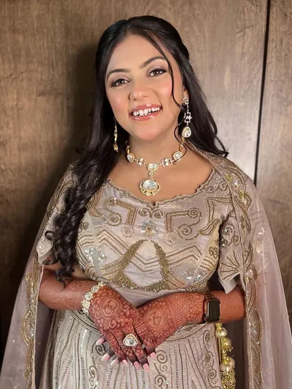 A happy smile from Aayushi. Her makeup is radiant and fresh, perfect for celebrating her engagement.