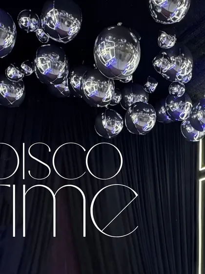 Disco Time! This graphic, combined with a ceiling of disco balls, announced the theme of the night in a bold and stylish way.