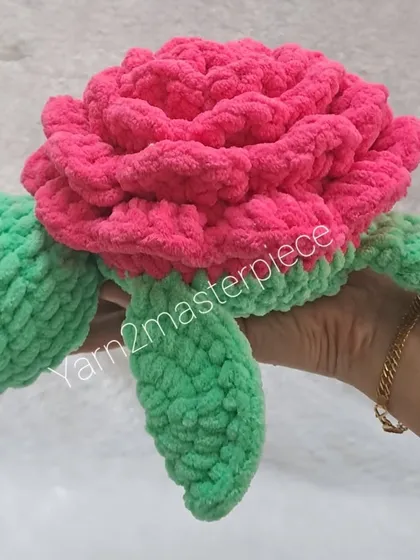Holding one of the 10-inch rose turtles to show its substantial size. It's a big, huggable toy that's sure to be loved.