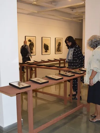 Visitors looking at the art and reading the provided materials at the exhibition.