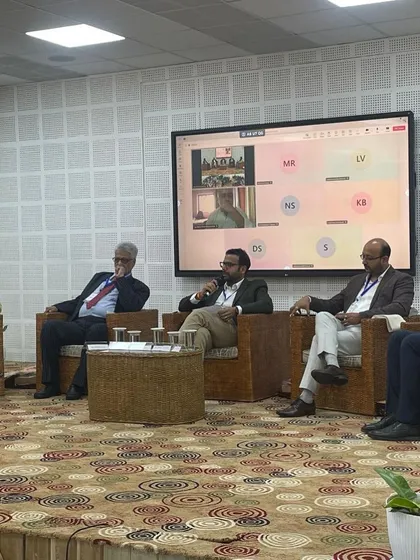 Saurabh Bindal moderating the panel discussion on technology transfer, which included virtual participants, showcasing a hybrid event format.
