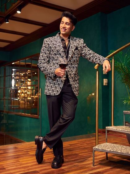 This jacket is designed to make an entrance. The black and white woven fabric creates a stunning visual texture, perfect for a high-fashion cocktail party or a celebratory event. I paired it with a simple black shirt to let the jacket be the hero of the outfit.