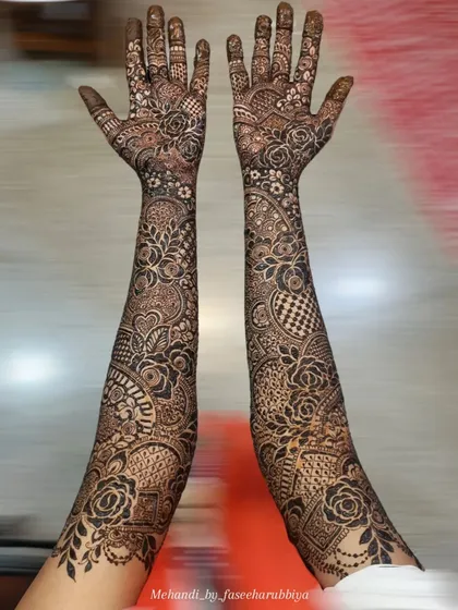 A full view of Neha's bridal hands, featuring a mix of bold roses and delicate, intricate filler work.
