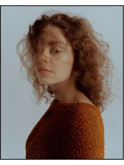 A soft, emotive portrait for Flanelle Magazine, with the model's hair gently blowing across her face.