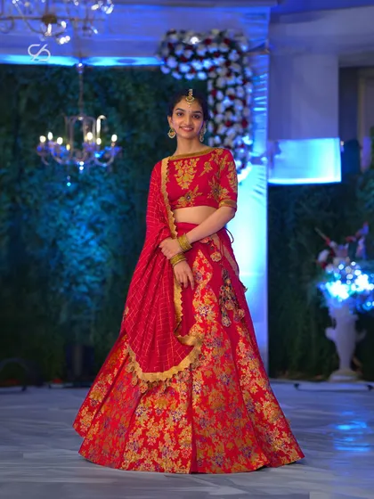 A vision of poise and grace. My client embodies pure elegance in this exquisite red suede lehenga, a perfect ensemble for a vibrant wedding celebration or festive occasion.