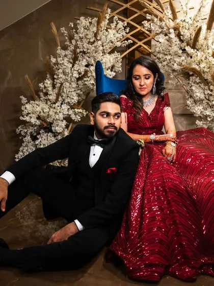 An editorial-style pose with the couple seated. This creates a relaxed yet stylish portrait, perfect for a modern wedding album.