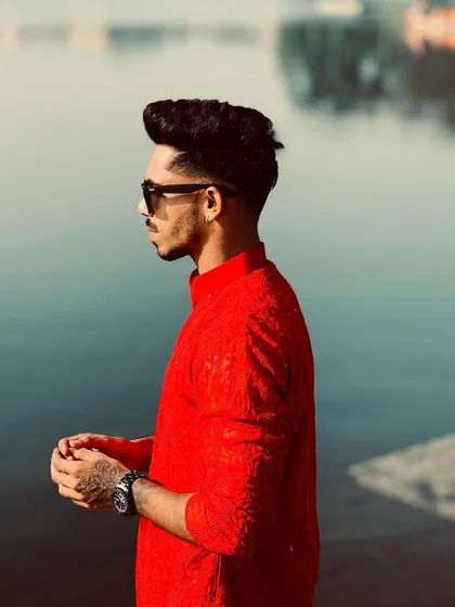 A side profile showing the fit and style of the red Chikankari kurta. It's a versatile piece that looks great for both casual gatherings and more formal events.