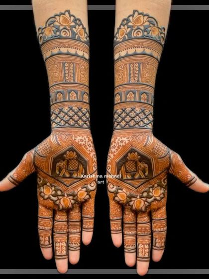 This design uses bold lines and shading to create a striking effect. It features elephant motifs on the palms and geometric bands on the arms, topped with a floral border.