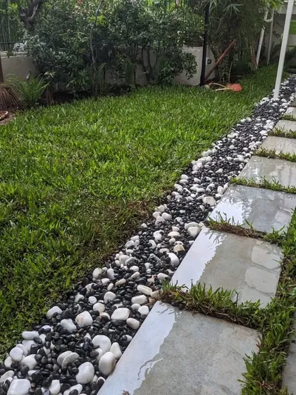 Another view of the finished pathway, showing how the grass, pebbles, and stones create a beautiful, multi-textured surface.