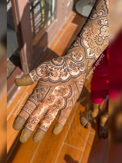 The palm side of Anam's Pakistani henna, showcasing the dense and detailed patterns.