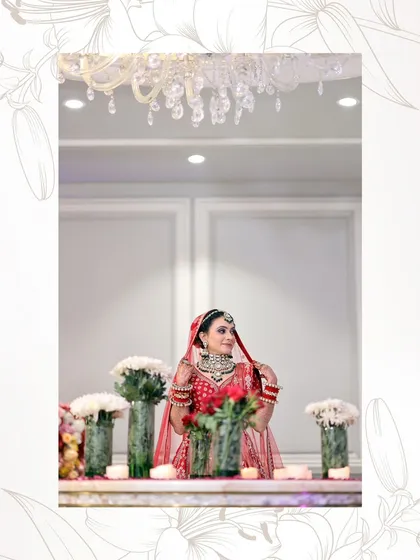 A beautiful shot of the bride at a decorated table. The setting complements her royal look perfectly.